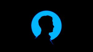 black profile of a person facing to the right. There is a blue circle around profile and a black background for the picture.