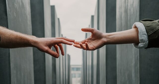 this is a picture of two hands reaching out to touch one another.