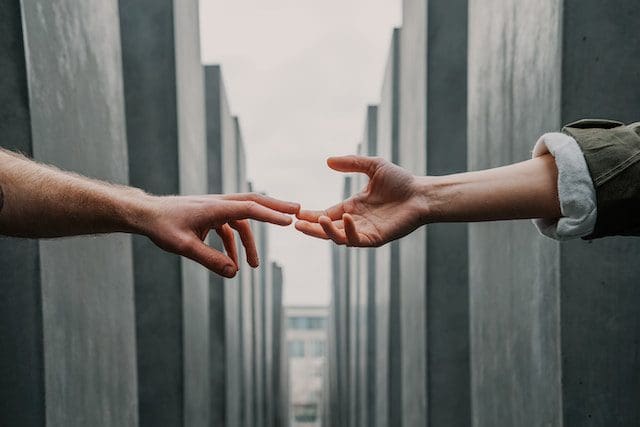 this is a picture of two hands reaching out to touch one another.