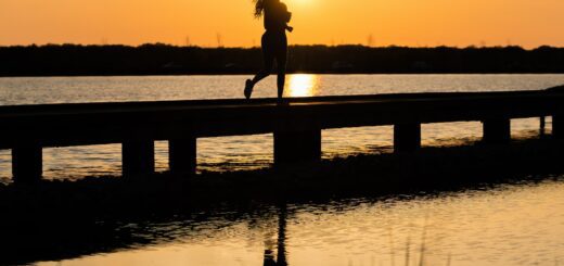 This is a picture of a woman running in the sunset/sunrise and all you see is her silhouette.