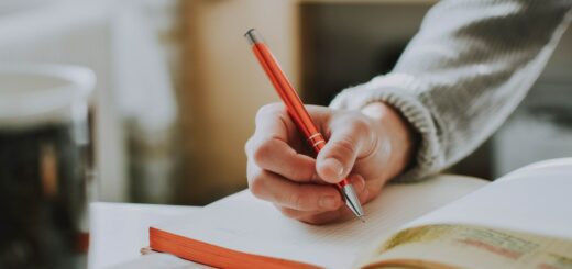 this is a photo of a hand holding a pen in the action of writing.