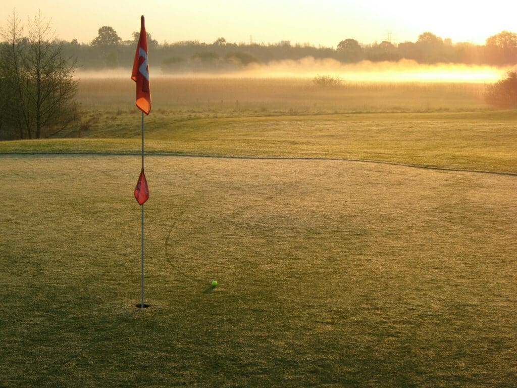 a flag for a hole of golf on a field